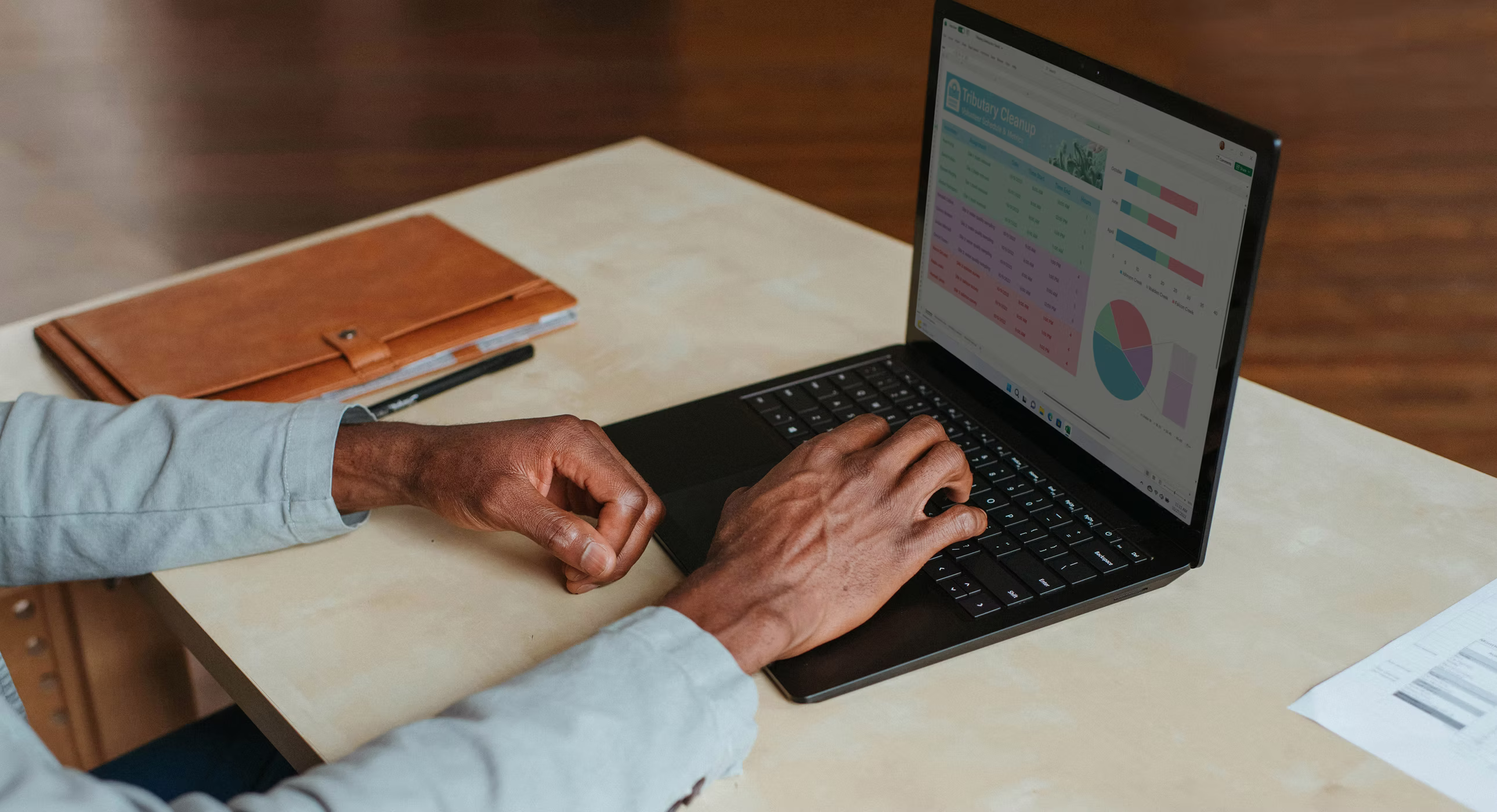 Person using a laptop displaying charts and data